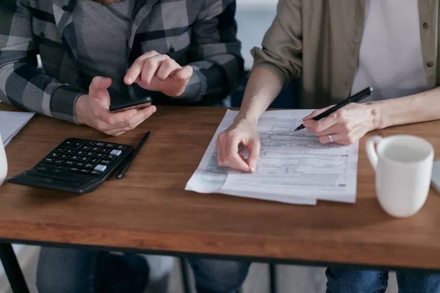 Two people reviewing a quote with a calculator