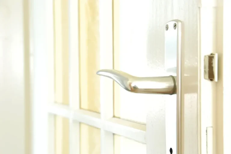 How to change a uPVC door lock in Farnborough – white door with a lever handle on a long backplate, Locksmith Farnborough guide to barrel, handle and multipoint replacement
