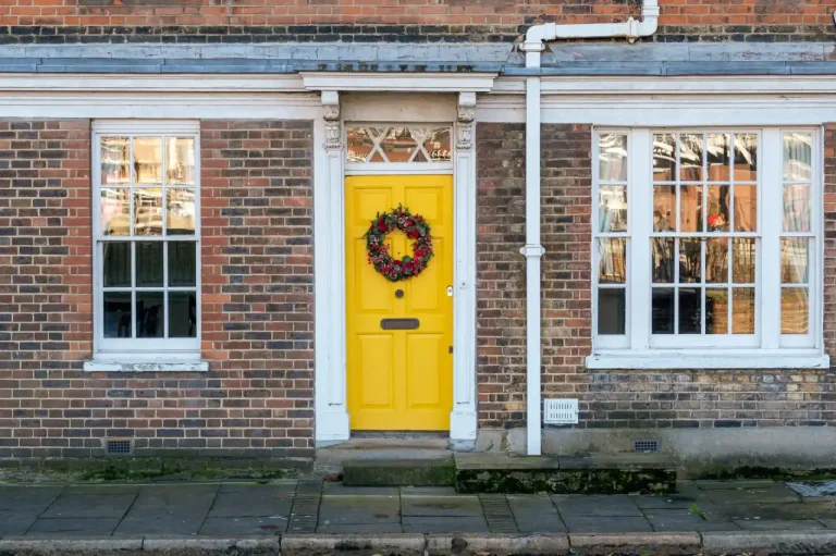 Types of door locks in the UK – yellow front door on a red-brick Victorian house in Farnborough, Locksmith Farnborough guide to identifying your lock